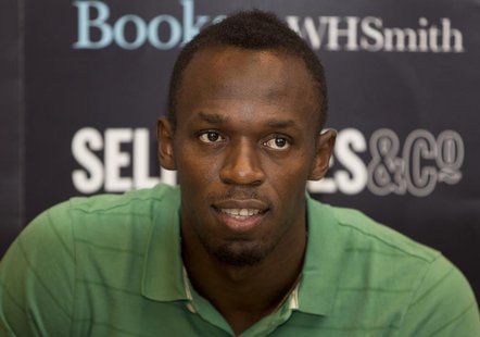 Jamaican athlete Usain Bolt poses for photographers as he signs copies of his autobiography, "Faster than Lightning," at Selfridges in centr Jamaican athlete Usain Bolt poses for photographers as he signs copies of his autobiography, "Faster than Lightning," at Selfridges in centr