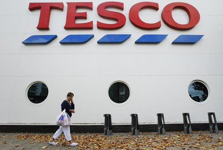 A shopper passes a Tesco supermarket in London October 5, 2011. REUTERS/Luke MacGregor A shopper passes a Tesco supermarket in London October 5, 2011. REUTERS/Luke MacGregor