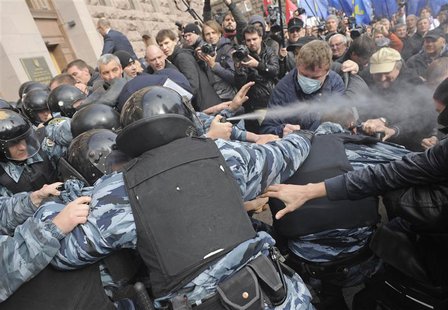 Activists of Ukrainian opposition parties clash with riot police as they attempt to get into the mayoral office during a rally against the K Activists of Ukrainian opposition parties clash with riot police as they attempt to get into the mayoral office during a rally against the K