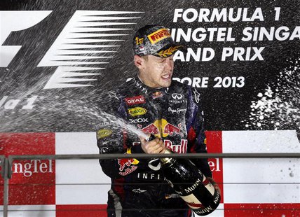 Red Bull Formula One driver Sebastian Vettel of Germany sprays champagne on the podium after winning the Singapore F1 Grand Prix at the Mari Red Bull Formula One driver Sebastian Vettel of Germany sprays champagne on the podium after winning the Singapore F1 Grand Prix at the Mari