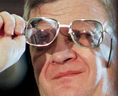 Novelist Tom Clancy checks his glasses in this file photo. Novelist Tom Clancy checks his glasses in this file photo.