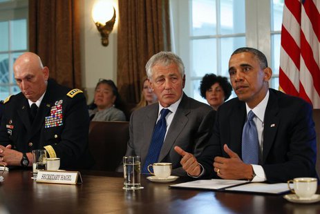 U.S. Army Chief of Staff General Ray Odierno (L) and Secretary of Defense Chuck Hagel listen as President Barack Obama (R) speaks to the med U.S. Army Chief of Staff General Ray Odierno (L) and Secretary of Defense Chuck Hagel listen as President Barack Obama (R) speaks to the med