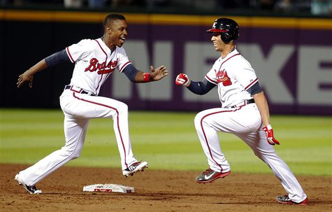 Atlanta Braves Andrelton Simmons (R) is chased by teammate B.J. Upton in celebration after Simmons hit a single knocking in the winning run Atlanta Braves Andrelton Simmons (R) is chased by teammate B.J. Upton in celebration after Simmons hit a single knocking in the winning run