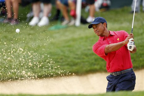U.S. Team player Tiger Woods hits out of a bunker on the 12th hole during the second practice round for the 2013 Presidents Cup golf tournam U.S. Team player Tiger Woods hits out of a bunker on the 12th hole during the second practice round for the 2013 Presidents Cup golf tournam