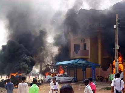 Cars burn in front of a building during protests over fuel subsidy cuts in Khartoum September 25, 2013. REUTERS/Stringer Cars burn in front of a building during protests over fuel subsidy cuts in Khartoum September 25, 2013. REUTERS/Stringer