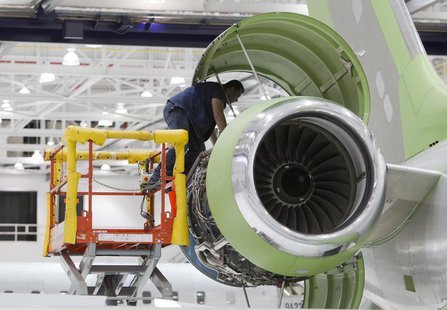 A worker looks at an engine on a Bombardier Global 5000 jet as its being assembled at the Bombardier aircraft manufacturing facility in Toro A worker looks at an engine on a Bombardier Global 5000 jet as its being assembled at the Bombardier aircraft manufacturing facility in Toro