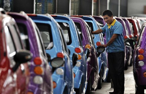An employee checks newly-assembled electric cars to be exported to South America at an electric vehicle factory in Zouping county, Shandong An employee checks newly-assembled electric cars to be exported to South America at an electric vehicle factory in Zouping county, Shandong