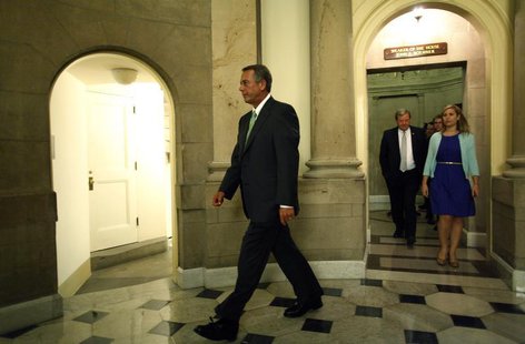 U.S. House Speaker John Boehner (L) departs his office with his staff to go to the House floor for a series of votes on partial budget measu U.S. House Speaker John Boehner (L) departs his office with his staff to go to the House floor for a series of votes on partial budget measu