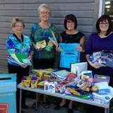 Members of the Harbor Center BID show off the donated school supplies received and given to area students. Members of the Harbor Center BID show off the donated school supplies received and given to area students.