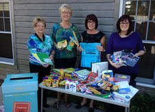 Members of the Harbor Center BID show off the donated school supplies received and given to area students. Members of the Harbor Center BID show off the donated school supplies received and given to area students.