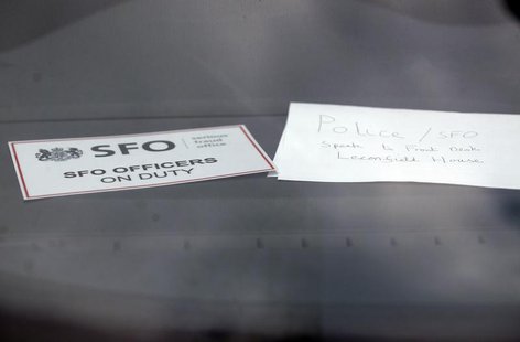 A sign is displayed in an unmarked Serious Fraud Office vehicle parked outside a building, in Mayfair, central London March 9, 2011. REUTERS A sign is displayed in an unmarked Serious Fraud Office vehicle parked outside a building, in Mayfair, central London March 9, 2011. REUTERS