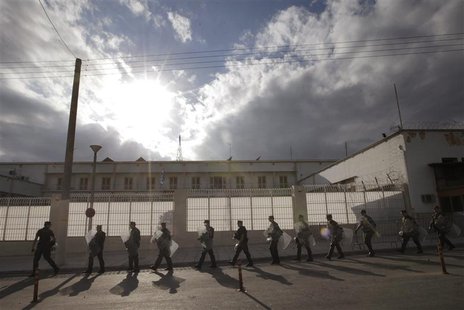 Riot policemen walk outside the Korydallos prison in Athens October 3, 2013. REUTERS/John Kolesidis Riot policemen walk outside the Korydallos prison in Athens October 3, 2013. REUTERS/John Kolesidis