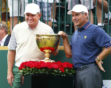International team captain Nick Price (L) poses next to the Presidents Cup with U.S. team captain Fred Couples before first round play begin International team captain Nick Price (L) poses next to the Presidents Cup with U.S. team captain Fred Couples before first round play begin