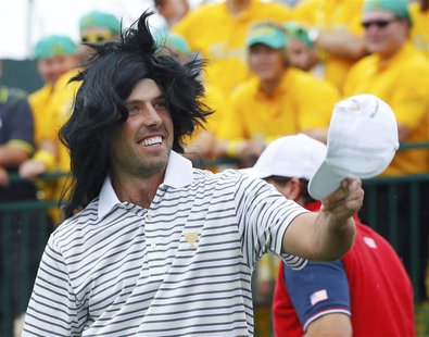 International team member Charl Schwartzel of South Africa greets fans on the first tee during the opening Four-ball matches for the 2013 Pr International team member Charl Schwartzel of South Africa greets fans on the first tee during the opening Four-ball matches for the 2013 Pr