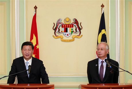 China's President Xi Jinping (L) speaks next to Malaysia's Prime Minister Najib Razak during a joint news conference at Najib's office in Pu China's President Xi Jinping (L) speaks next to Malaysia's Prime Minister Najib Razak during a joint news conference at Najib's office in Pu