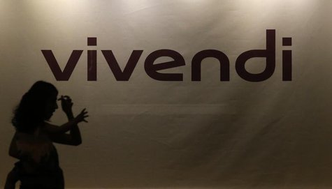A woman holding a young girl in her arms is silhouetted as she walks past the main entrance of the entertainment-to-telecoms conglomerate Vi A woman holding a young girl in her arms is silhouetted as she walks past the main entrance of the entertainment-to-telecoms conglomerate Vi