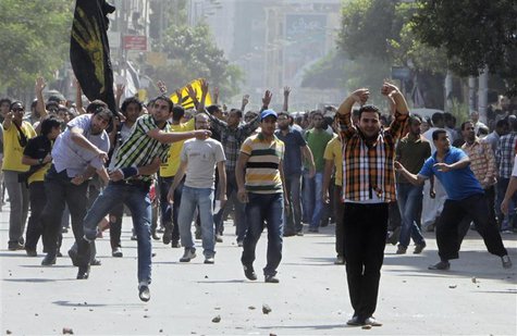 Supporters of deposed President Mohamed Mursi and the Muslim Brotherhood clash with anti-Mursi protesters during a march in Shubra street in Supporters of deposed President Mohamed Mursi and the Muslim Brotherhood clash with anti-Mursi protesters during a march in Shubra street in