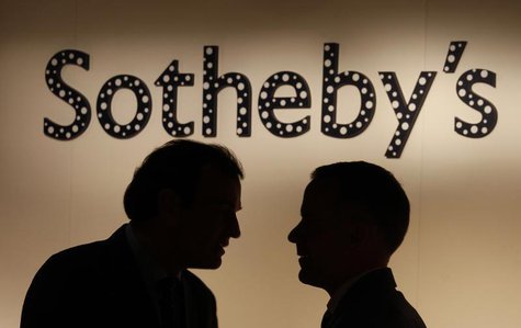Two men chat in front of a polka dot covered Sotheby's signage, part of an installation by Japanese artist Yayoi Kusama, at Sotheby's newly Two men chat in front of a polka dot covered Sotheby's signage, part of an installation by Japanese artist Yayoi Kusama, at Sotheby's newly