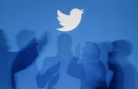 The shadows of people holding mobile phones are cast onto a backdrop projected with the Twitter logo in this illustration picture taken in W The shadows of people holding mobile phones are cast onto a backdrop projected with the Twitter logo in this illustration picture taken in W