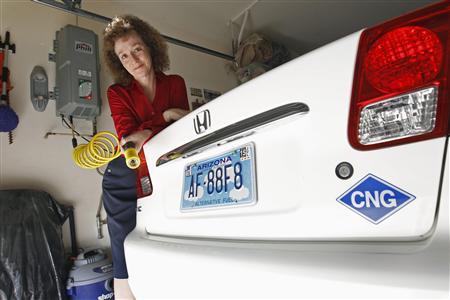 Connie Jones with her 2003 natural gas powered Honda Civic and natural gas home refueling station located on the garage wall of her home in Chandler, Arizona, October 3, 2013.
REUTERS/Ralph D. Freso Connie Jones with her 2003 natural gas powered Honda Civic and natural gas home refueling station located on the garage wall of her home in Chandler, Arizona, October 3, 2013.
REUTERS/Ralph D. Freso