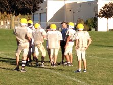 The team huddles around coach Feldmann The team huddles around coach Feldmann
