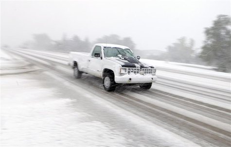 A pickup drives on Highway 44 as heavy snow falls in Rapid City, South Dakota, October 4, 2013. REUTERS/Chris Huber/Rapid City Journal A pickup drives on Highway 44 as heavy snow falls in Rapid City, South Dakota, October 4, 2013. REUTERS/Chris Huber/Rapid City Journal