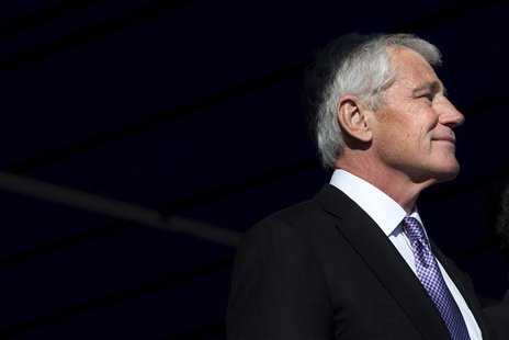 U.S. Secretary of Defense Chuck Hagel, illuminated by a beam of sunlight, attends a change of command ceremony, that sees U.S. Army General U.S. Secretary of Defense Chuck Hagel, illuminated by a beam of sunlight, attends a change of command ceremony, that sees U.S. Army General