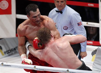 Heavyweight world champion Vladimir Klitschko (L) of Ukraine and challenger Alexander Povetkin of Russia exchange punches during their heavy Heavyweight world champion Vladimir Klitschko (L) of Ukraine and challenger Alexander Povetkin of Russia exchange punches during their heavy