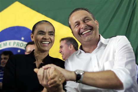 Former Senator Marina Silva (L) reacts with Pernambuco state Governor Eduardo Campos during a meeting where Silva announced her decision to Former Senator Marina Silva (L) reacts with Pernambuco state Governor Eduardo Campos during a meeting where Silva announced her decision to