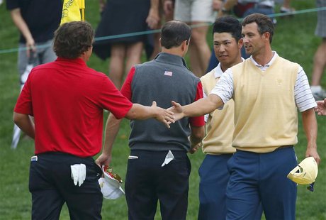 Jason Dufner (L) of the U.S. shakes hands with Adam Scott (R) of Australia as Zach Johnson of the U.S. shakes hands with Hideki Matsuyama of Jason Dufner (L) of the U.S. shakes hands with Adam Scott (R) of Australia as Zach Johnson of the U.S. shakes hands with Hideki Matsuyama of
