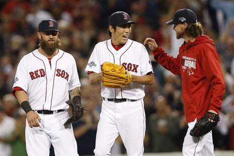 Oct 5, 2013; Boston, MA, USA; Boston Red Sox first baseman Mike Napoli (12) celebrates with pitcher Koji Uehara (19) and pitcher Clay Buchho Oct 5, 2013; Boston, MA, USA; Boston Red Sox first baseman Mike Napoli (12) celebrates with pitcher Koji Uehara (19) and pitcher Clay Buchho