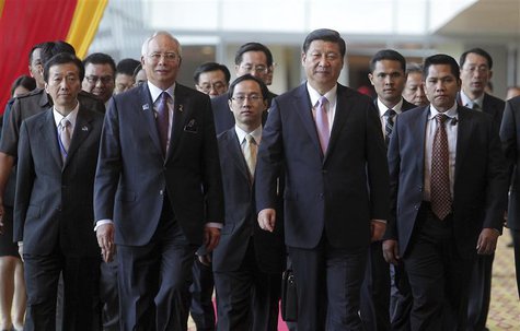 Malaysian Prime Minister Najib Razak (front, L) walks with Chinese President Xi Jinping (front, R) during the Malaysia China Economic Summit Malaysian Prime Minister Najib Razak (front, L) walks with Chinese President Xi Jinping (front, R) during the Malaysia China Economic Summit