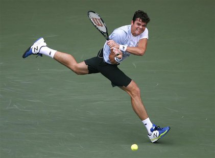 Milos Raonic of Canada returns a shot to Juan Martin Del Potro of Argentina during their men's singles final match at the Japan Open tennis Milos Raonic of Canada returns a shot to Juan Martin Del Potro of Argentina during their men's singles final match at the Japan Open tennis