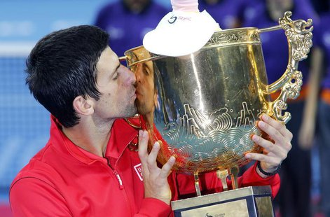 Novak Djokovic of Serbia kisses the trophy after winning his men's singles final match against Rafael Nadal of Spain at the China Open tenni Novak Djokovic of Serbia kisses the trophy after winning his men's singles final match against Rafael Nadal of Spain at the China Open tenni