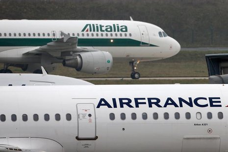 An Alitalia plane passes an Air France plane on the tarmac of Charles de Gaulles International Airport in Roissy near Paris, January 8, 2013 An Alitalia plane passes an Air France plane on the tarmac of Charles de Gaulles International Airport in Roissy near Paris, January 8, 2013
