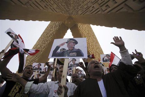 Supporters of the army hold posters of late Egyptian President Anwar Sadat as they protest against ousted Islamist President Mohamed Mursi a Supporters of the army hold posters of late Egyptian President Anwar Sadat as they protest against ousted Islamist President Mohamed Mursi a
