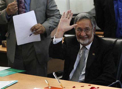 Afghanistan's former Foreign Minister Zalmay Rassoul (R) waits to register as a candidate for the presidential election at Afghanistan's Ind Afghanistan's former Foreign Minister Zalmay Rassoul (R) waits to register as a candidate for the presidential election at Afghanistan's Ind