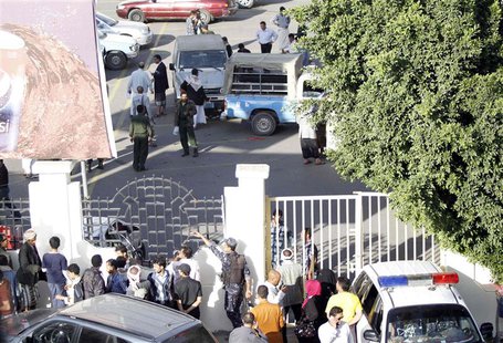 People gather outside a supermarket carpark after a shooting in Sanaa October 6, 2013. REUTERS/Mohamed al-Sayaghi People gather outside a supermarket carpark after a shooting in Sanaa October 6, 2013. REUTERS/Mohamed al-Sayaghi