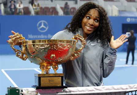 Serena Williams of the U.S. reacts as she poses with the trophy after winning her women's singles final match against Jelena Jankovic of Ser Serena Williams of the U.S. reacts as she poses with the trophy after winning her women's singles final match against Jelena Jankovic of Ser
