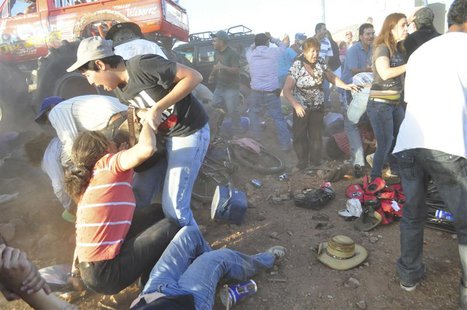 Spectators react after a monster truck rammed the stand where they were watching a monster truck rally show at El Rejon park, on the outskir Spectators react after a monster truck rammed the stand where they were watching a monster truck rally show at El Rejon park, on the outskir