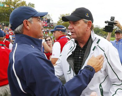 International captain Nick Price (R) congratulates U.S. captain Fred Couples after the U.S. won the 2013 Presidents Cup golf tournament at M International captain Nick Price (R) congratulates U.S. captain Fred Couples after the U.S. won the 2013 Presidents Cup golf tournament at M