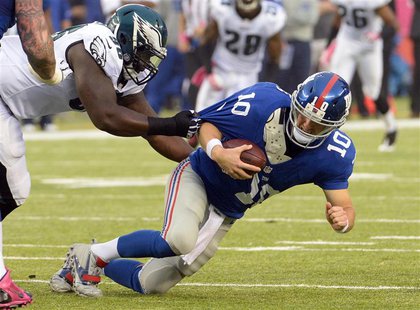 Oct 6, 2013; East Rutherford, NJ, USA; New York Giants quarterback Eli Manning (10) is sacked by Philadelphia Eagles defensive tackle Bennie Oct 6, 2013; East Rutherford, NJ, USA; New York Giants quarterback Eli Manning (10) is sacked by Philadelphia Eagles defensive tackle Bennie