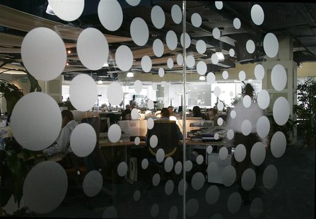 The new Thomson Reuters logo is seen as employees sit at their desks in the Dubai office April 17, 2008. REUTERS/Jumana El Heloueh The new Thomson Reuters logo is seen as employees sit at their desks in the Dubai office April 17, 2008. REUTERS/Jumana El Heloueh