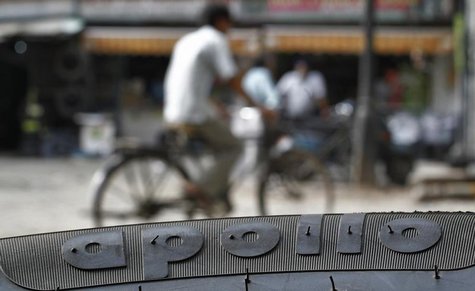 A cyclist rides past an Apollo tyre kept on display at a multi-brand tyre showroom in New Delhi June 13, 2013. REUTERS/Anindito Mukherjee A cyclist rides past an Apollo tyre kept on display at a multi-brand tyre showroom in New Delhi June 13, 2013. REUTERS/Anindito Mukherjee