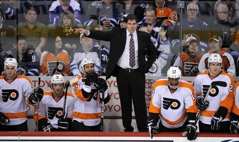 Philadelphia Flyers head coach Peter Laviolette instructs his team against the Winnipeg Jets during the third period of their NHL hockey gam Philadelphia Flyers head coach Peter Laviolette instructs his team against the Winnipeg Jets during the third period of their NHL hockey gam