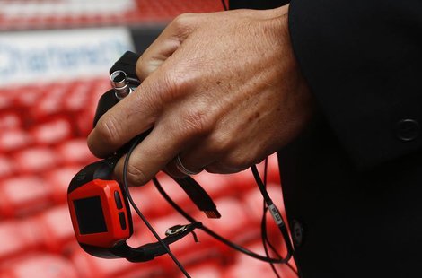 Assistant Referee Lee Probert holds a watch linked to the Hawkeye system before the English Premier League soccer match between Liverpool an Assistant Referee Lee Probert holds a watch linked to the Hawkeye system before the English Premier League soccer match between Liverpool an