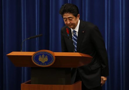 Japan's Prime Minister Shinzo Abe bows at the end of a news conference to announce a raise in the sales tax rate at his official residence i Japan's Prime Minister Shinzo Abe bows at the end of a news conference to announce a raise in the sales tax rate at his official residence i