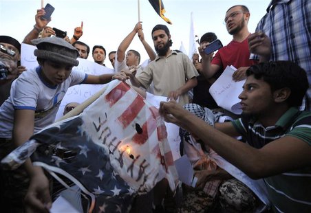 Protesters burn a replica of the U.S. flag during a protest against the capture of Nazih al-Ragye, in Benghazi October 7, 2013. REUTERS/Esam Protesters burn a replica of the U.S. flag during a protest against the capture of Nazih al-Ragye, in Benghazi October 7, 2013. REUTERS/Esam