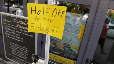 A sign at a fitness studio advertises a deal for furloughed government workers in the Capitol Hill neighborhood in Washington on October 5, 2013. REUTERS/Jonathan Ernst A sign at a fitness studio advertises a deal for furloughed government workers in the Capitol Hill neighborhood in Washington on October 5, 2013. REUTERS/Jonathan Ernst