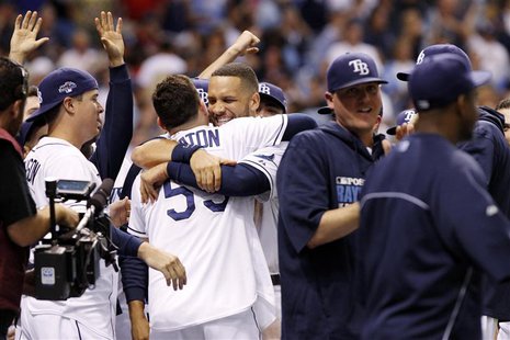 Oct 7, 2013; St. Petersburg, FL, USA; Tampa Bay Rays catcher Jose Lobaton (59) is congratulated by first baseman James Loney (middle, facing Oct 7, 2013; St. Petersburg, FL, USA; Tampa Bay Rays catcher Jose Lobaton (59) is congratulated by first baseman James Loney (middle, facing